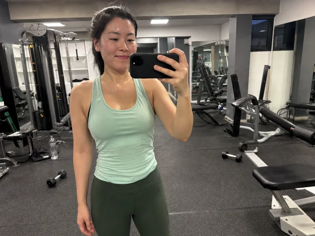 Woman taking a casual mirror selfie after a gym workout